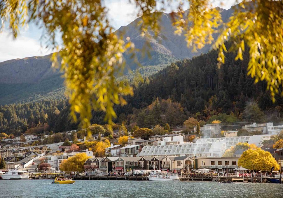 Steamer Wharf on the Queenstown waterfront framed by autumn leaves